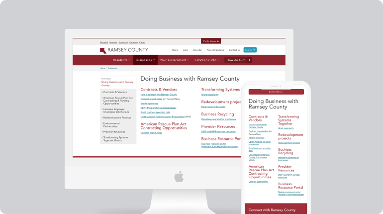 A computer monitor and smartphone display the Ramsey County website page titled Doing Business with Ramsey County. The page offers custom software solutions and resources for vendors. Experience its user-friendly design in a striking red and white color scheme, facilitating seamless business interactions.
