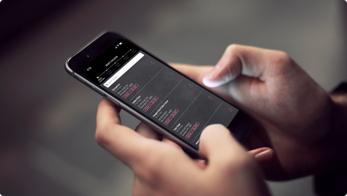 person holding mobile phone symbolizing the automated reporting system we created for haagen dazs franchise owners to report store metrics.